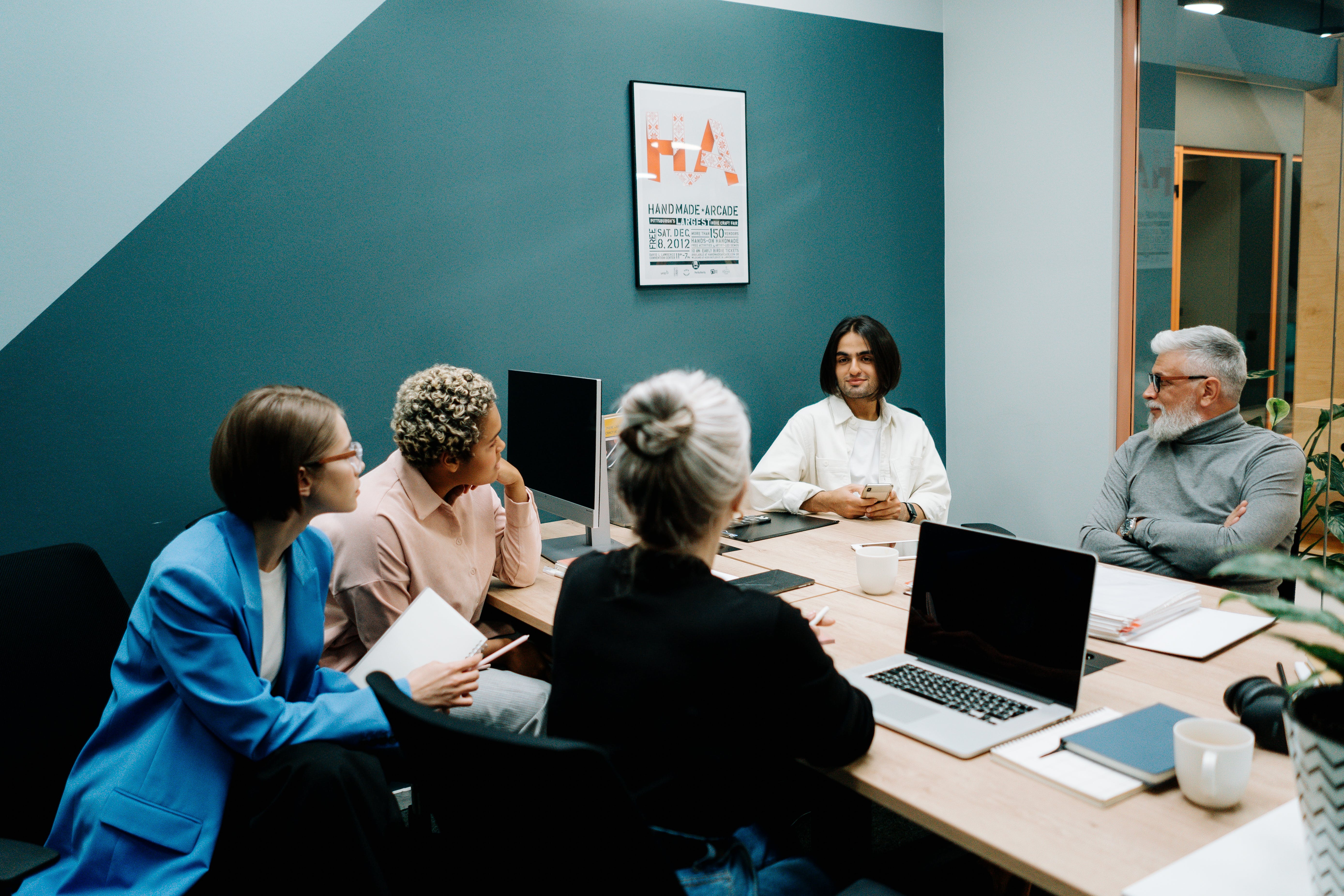 Personas trabajando alrededor de una mesa y hablando sobre que es seniority.